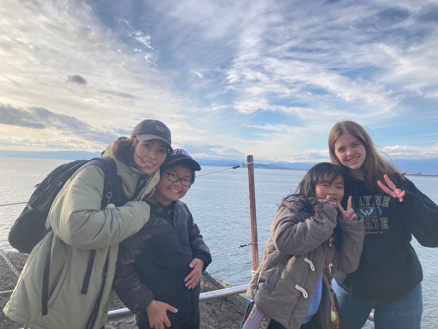 A group of people with Mt. Fuji in the distance.